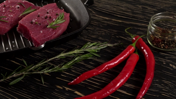 Beef Fillet on a Pan with Pepper, Rosemary and Garlic.