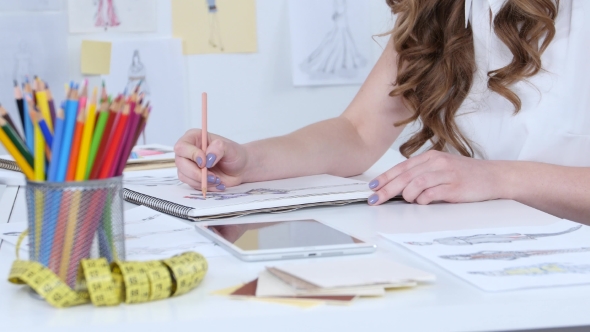 Artist Sits in Her Study, Sketches a New Collection. alt