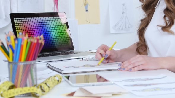 Artist Sits in Her Study, Sketches a New Collection. alt