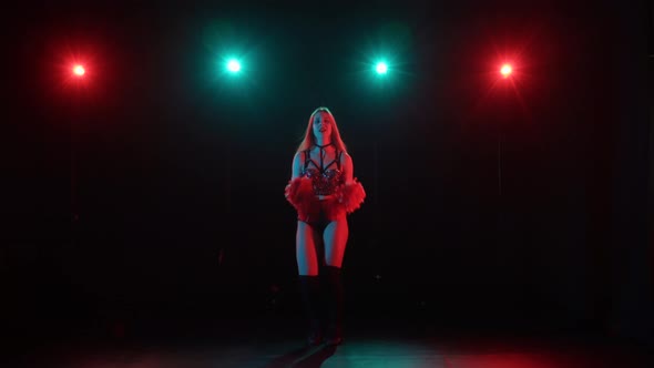 Cute Young Cheerleader is Dancing Cheering Dance Waving Orange Pompoms alt