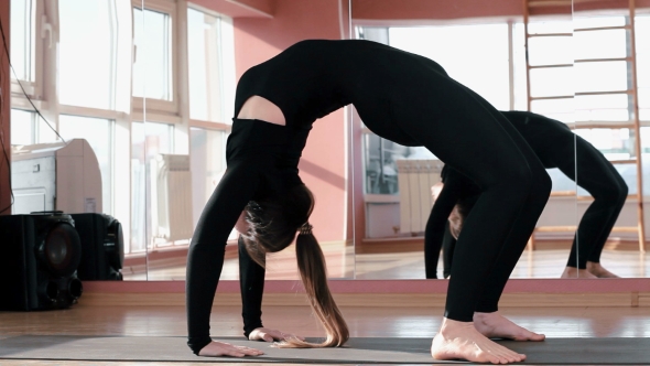 Girl in a Gym Doing Exercises
