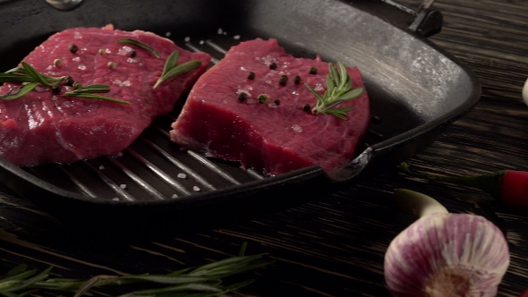 Beef Fillet on a Pan with Pepper, Rosemary and Garlic.