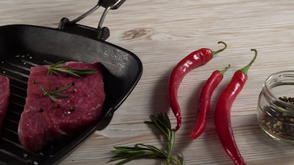 Beef Fillet on a Pan with Pepper, Rosemary, Oil and Garlic.