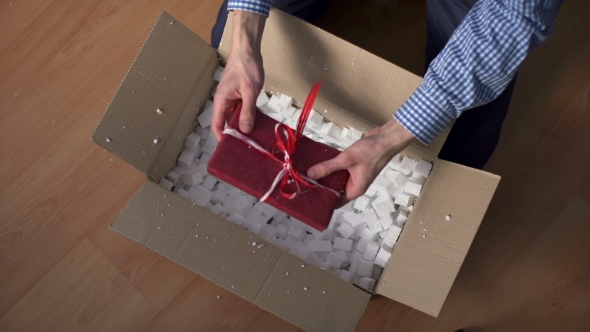 Man Hands Opening a Parcel Contains a Gift