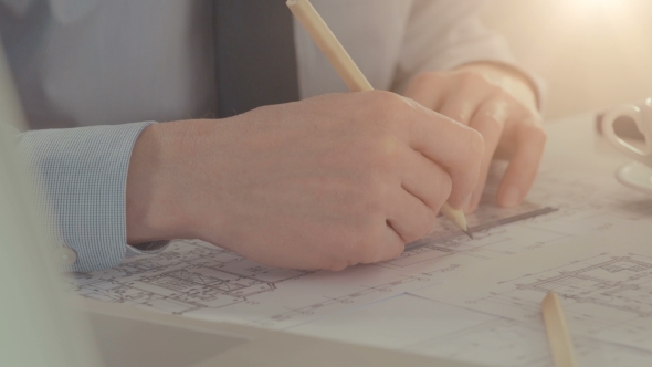 Male Architect Draws a Construction Project. alt