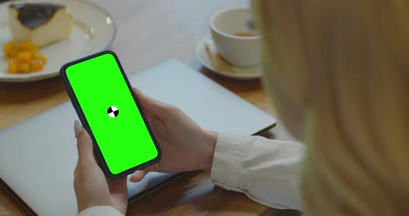 Business Woman Using Smartphone Viewing Green Screen on Mobile Phone Browsing Chroma Key Online alt