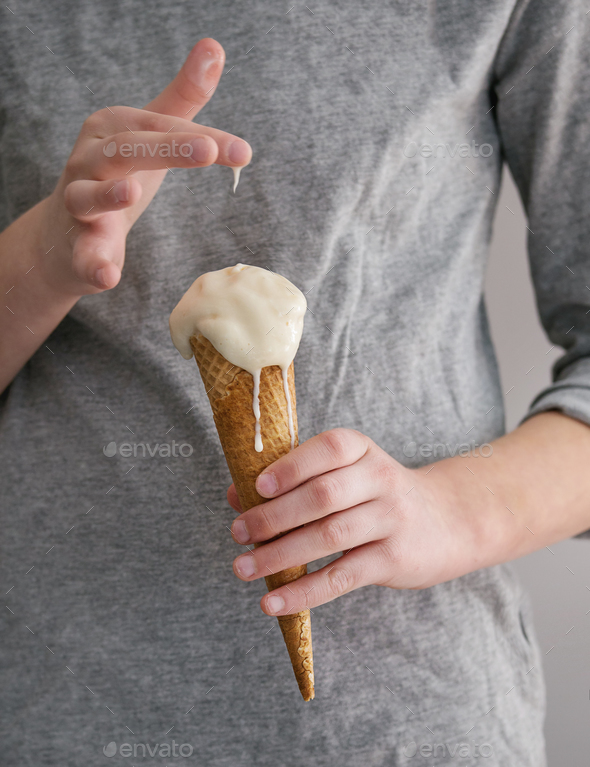 Ice cream in waffle cane in boy\'s hands