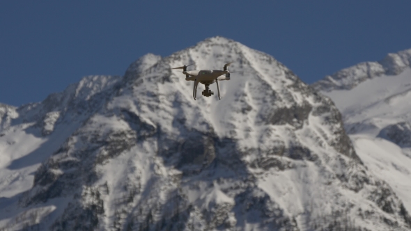 Drone on a Background of Snow-capped Peaks
