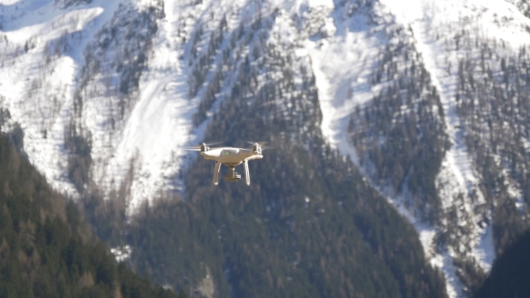 Dron on the Background of a Snowy Slope
