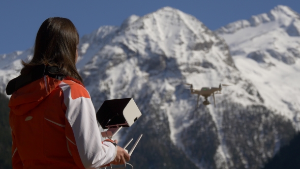 Woman with a Remote Control Controls the Drone