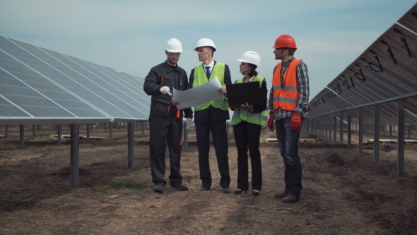Group of Engineers or Technicians on a Solar Farm alt