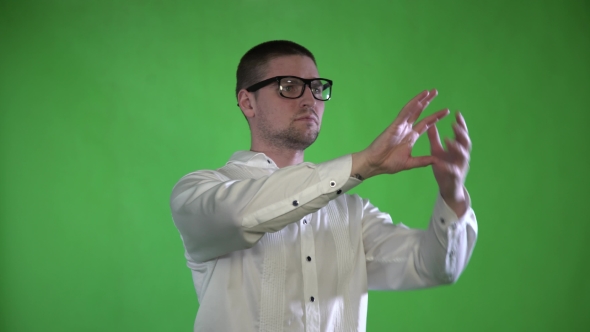A Textured Man with Bristles and Glasses Controls His Hands with a Hologram on a Green Background alt