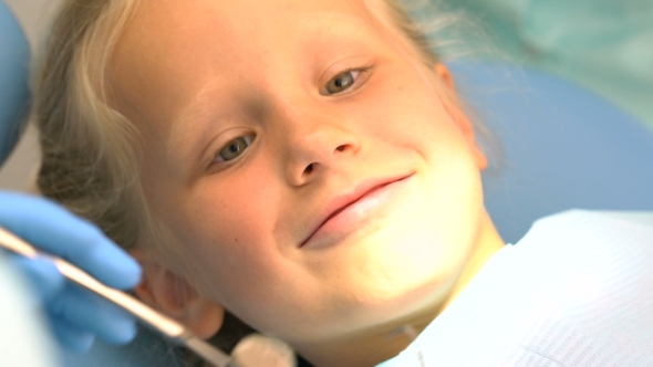 Little Girl Sitting in the Dentists Office alt