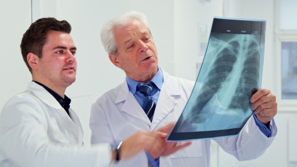 Two Male Doctors Look at X-ray alt