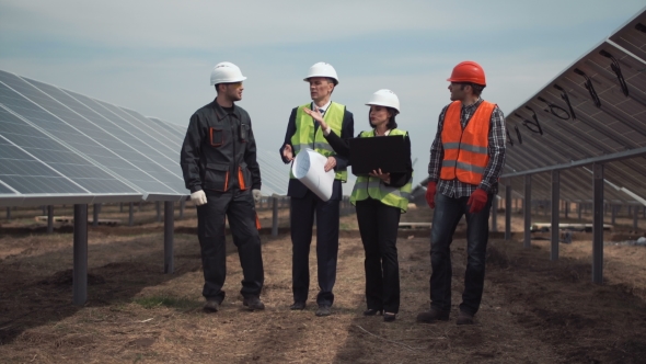 Group of Engineers or Technicians on a Solar Farm alt