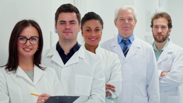 Female Doctor Writes on Her Clipboard alt