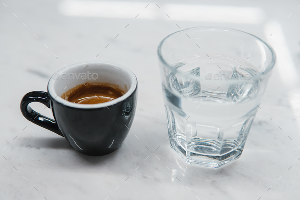cup with coffee near a glass of water - Stock Photo - Images