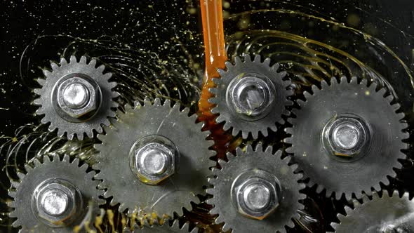 Super Slow Motion Shot of Gear Mechanism and Oil on Dark Background at 1000 Fps alt