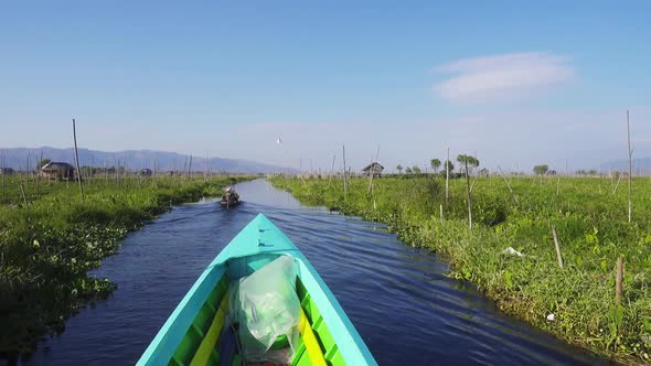 Boat Floats Among Floating Gardens on Inle Lake alt