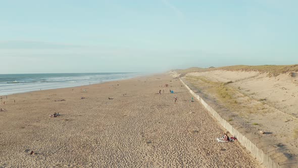 Beautiful Beach in South of France Coast with People Enjoying Time in the Sand on Sunny Day, Aerial alt