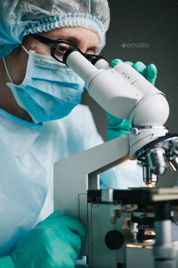 Scientist working in laboratory with microscope - Stock Photo - Images