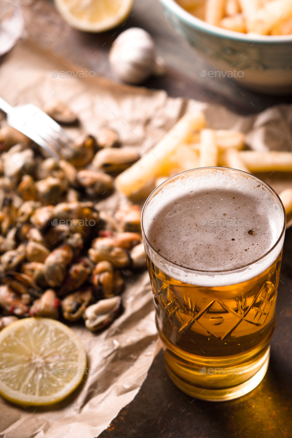 Glass of beer with blurred snack vertical - Stock Photo - Images