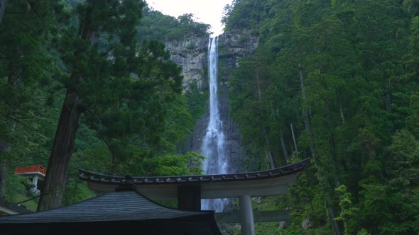 Nachi Falls Cascading Down Rocks Surrounded By Lush Green Forest. Locked Off, Low Angle alt