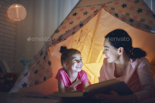 Mom and child are reading book - Stock Photo - Images