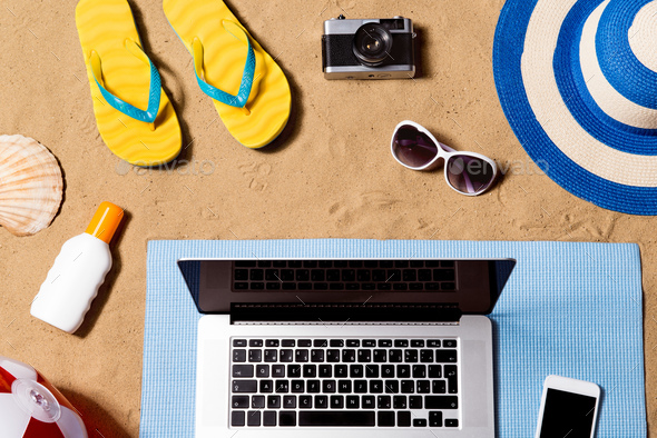 Summer vacation composition. Sandals, hat, laptop and smartphone - Stock Photo - Images