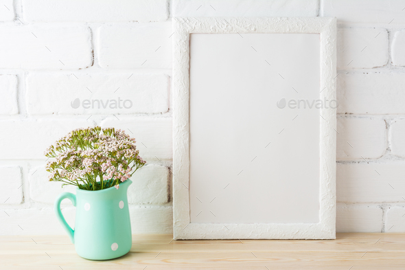 White frame mockup with soft pink flowers near exposed bricks - Stock Photo - Images
