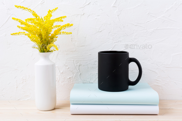 Black coffee mug mockup with ornamental golden grass and books Stock Photo by TasiPas