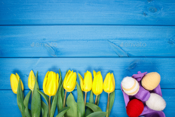 Bouquet of fresh tulips and Easter eggs wrapped woolen string - Stock Photo - Images