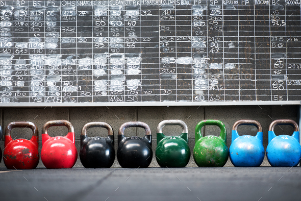 Row of colorful pairs of kettlebell weights - Stock Photo - Images