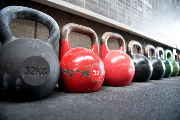 Long receding row of kettlebell weights in a gym - Stock Photo - Images