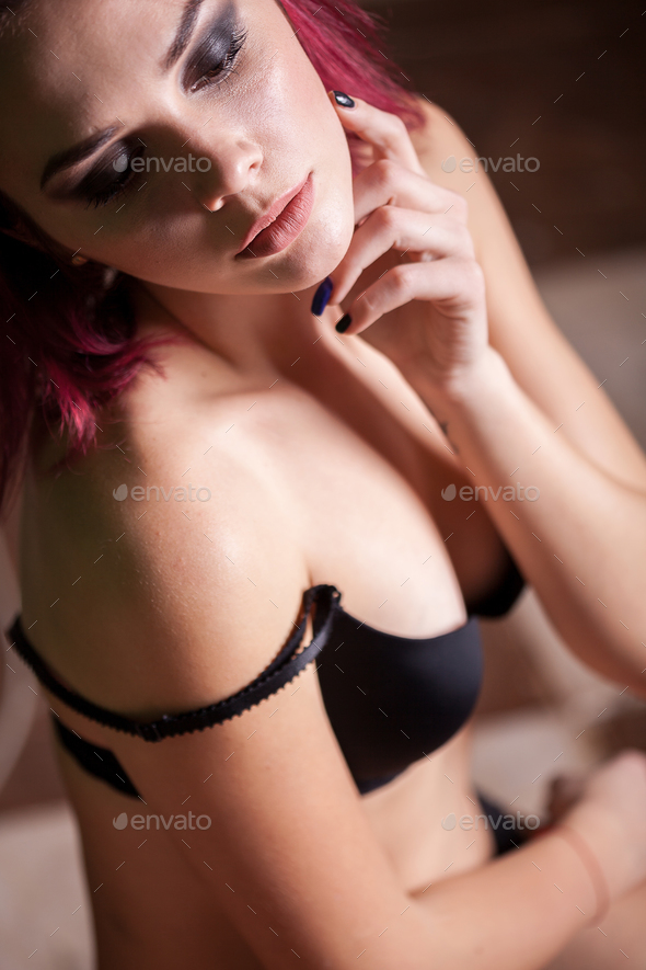Sexy hot redhead babe in lingerie in soft focus image