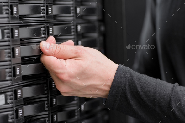 IT consultant maintain large SAN array in datacenter Stock Photo by kjekol