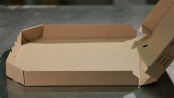 Chef Puts the Pizza Inside a Pizza Box Ready for Delivery