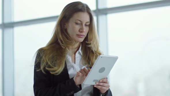Businesswoman Typing on Tablet alt