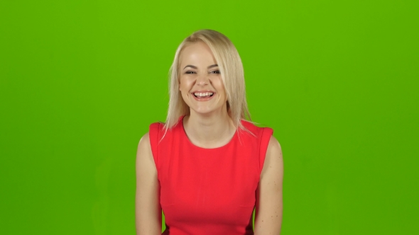 Blonde Girl in Red Dress Sincerely, Contagious Laughs. Green Screen alt