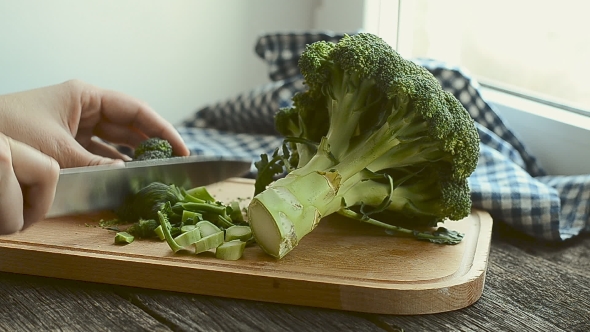 Fresh Green Broccoli Being Chopped Into Pieces