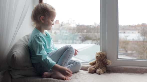 Girl Playing with Teddy Bear