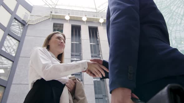 Handshake between Caucasian businesswoman and Arabian businessman