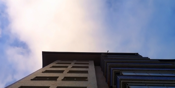 Building With Clouds Passing