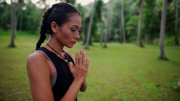Asian Woman Meditating in the Jungle alt