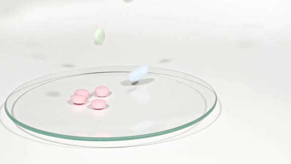 Closeup of Different Medical Pills Falling on Petri Dish on White Background alt
