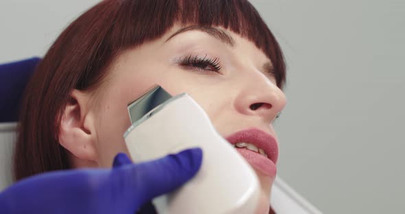 Professional Cosmetologist Working with Ultrasonic Facial Machine While Doing alt