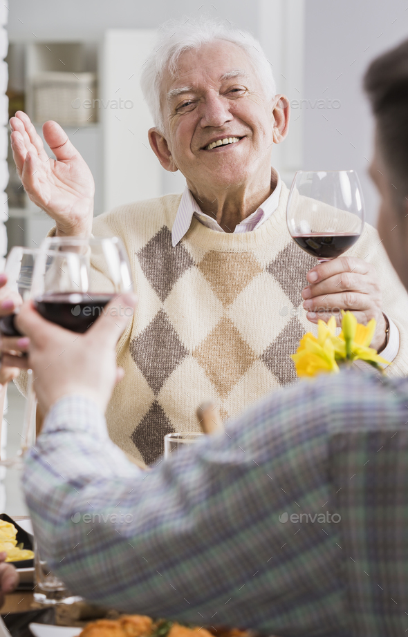 Man and elderly father making a toast