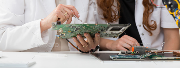 Students analyzing computer components - Stock Photo - Images