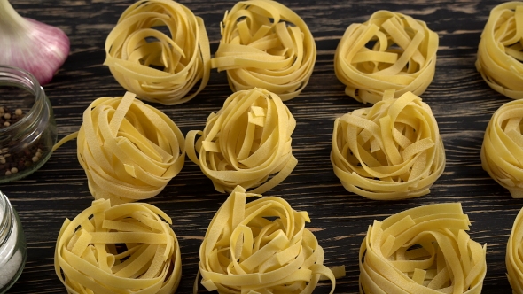 Pasta, Oil, Tomatos and Garlic on Wooden Background