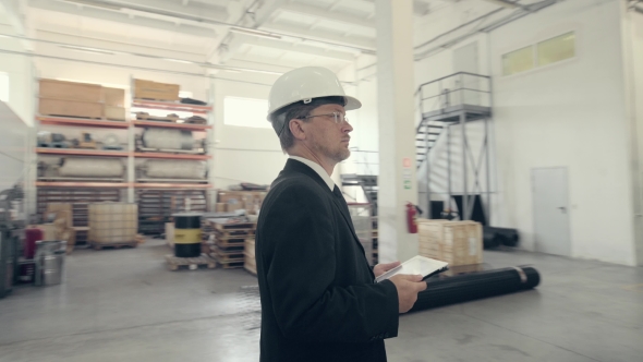 Businessman Using Tablet Pc at Manufacturing Plant alt